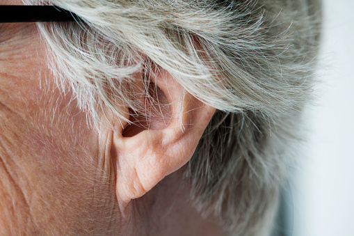 Closeup of elderly woman's ear