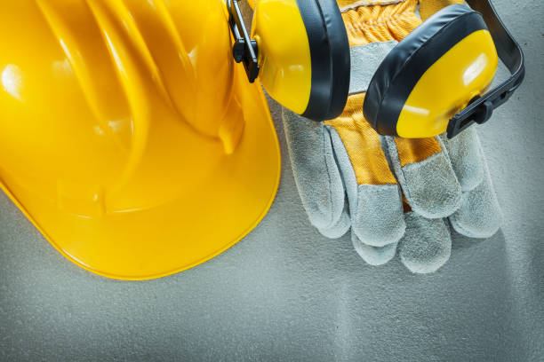 istock Earmuffs protective gloves building helmet on concrete backgroun 918020616