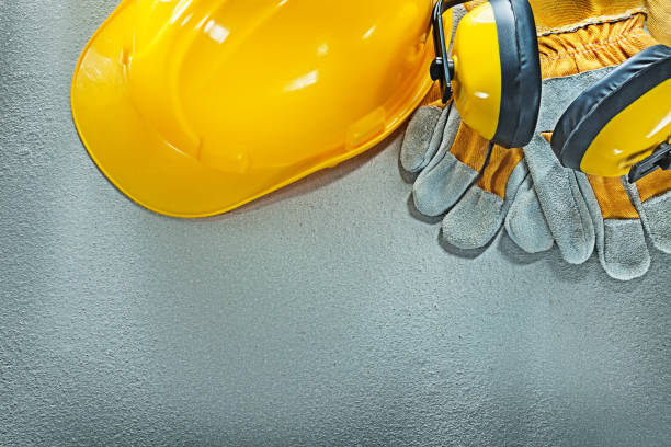 istock Earmuffs safety gloves hard hat on concrete background 918020700