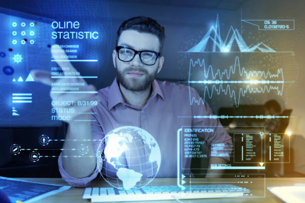 istock Young smart programmer pointing to the transparent screen and looking confident 918020796