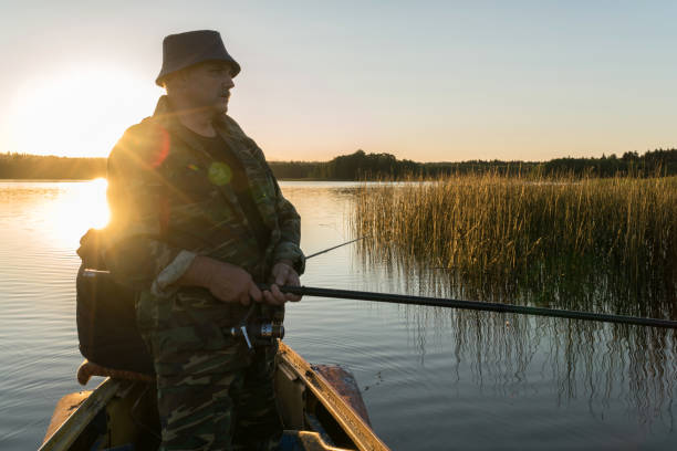 istock A man is fishing from a boat on sunset 918020894