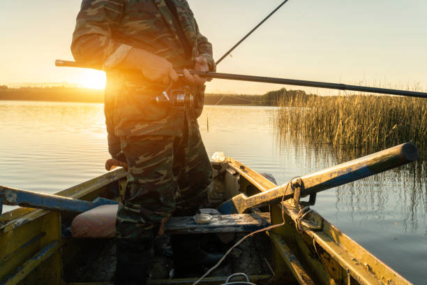 istock A man is fishing from a boat on sunset 918020922