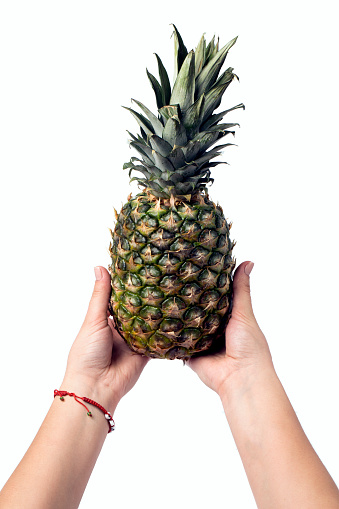 pineapple in hand isolated on white background