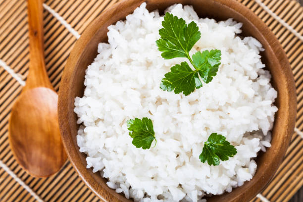 istock Boiled rice in a wooden bowl and spoon 918023958