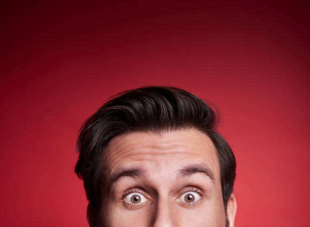 istock Part of terrified man peeking at studio shot 918024666