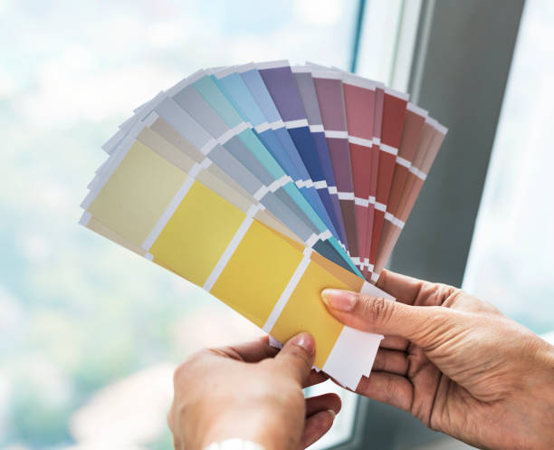 istock Closeup of hands holding color swatch 918024672