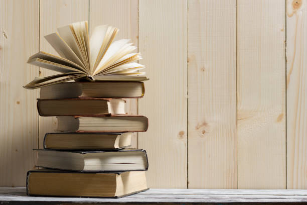 istock Open book, hardback books on wooden table. Back to school. Copy space 918027048