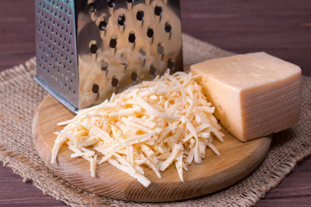 istock Grated cheese on a wooden cutting board 918027928