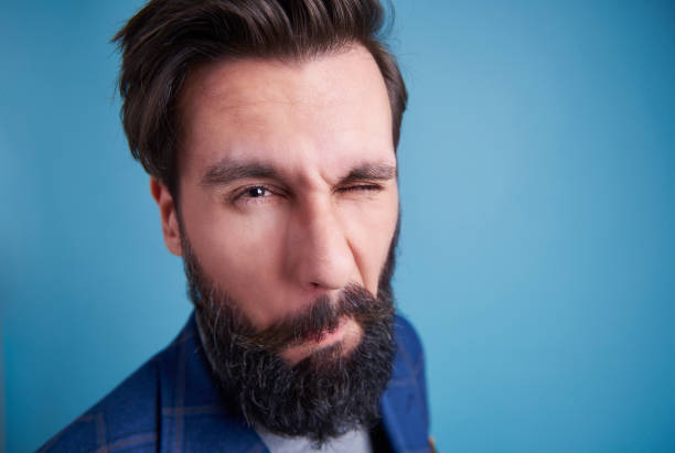 istock Shot of man with beard winking 918028054