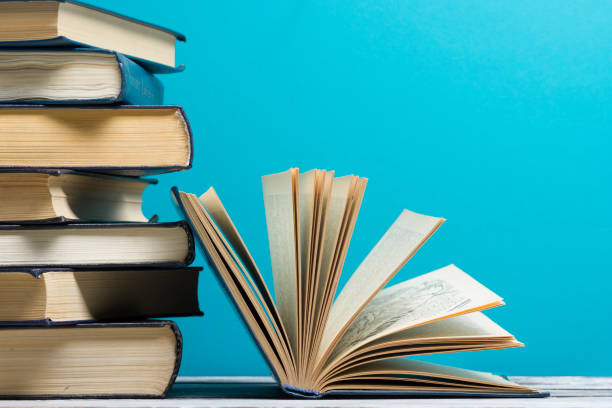 istock Open book, hardback books on wooden table. Back to school. Copy space 918028114