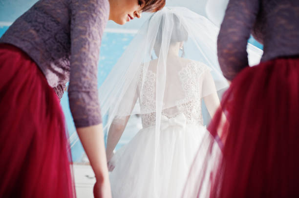 istock Beautiful bride posing with bridesmaids in her room 918030416