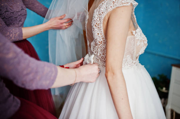 istock Beautiful bride posing with bridesmaids in her room 918030418