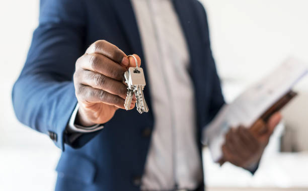 istock Real estate agent handing the house key 918030734
