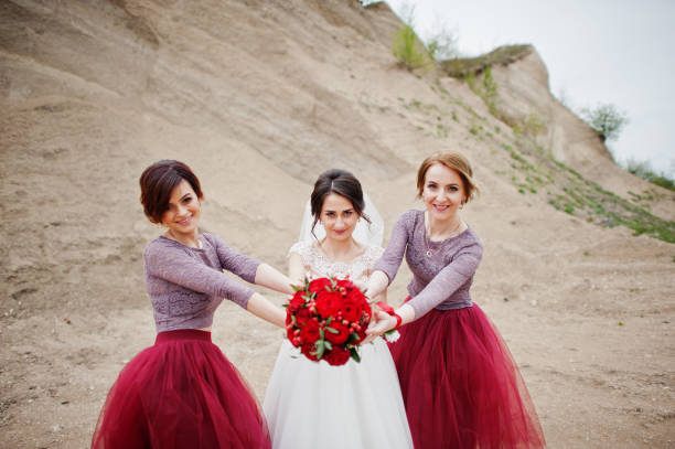 istock Bride posing with her bridesmaids in sand quarry on her wedding day. 918031478