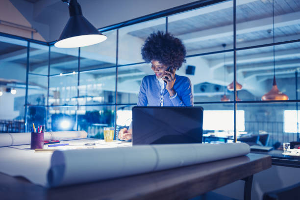 istock Working Late. Young woman, architect working late in office 918035428