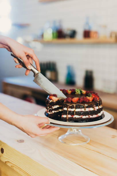 istock woman cutting chocolate cake 918035614