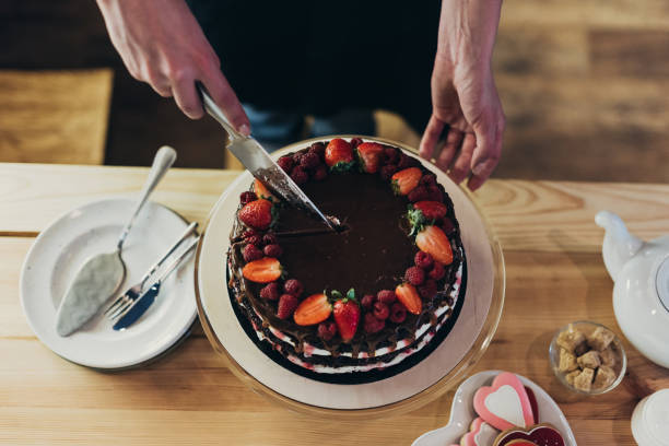 istock woman cutting chocolate cake 918035904