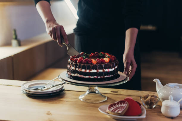 istock woman cutting chocolate cake 918038404