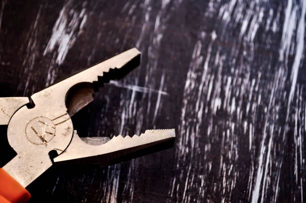 istock Pliers for repair work lying on the table. Repair tools in the h 918038754