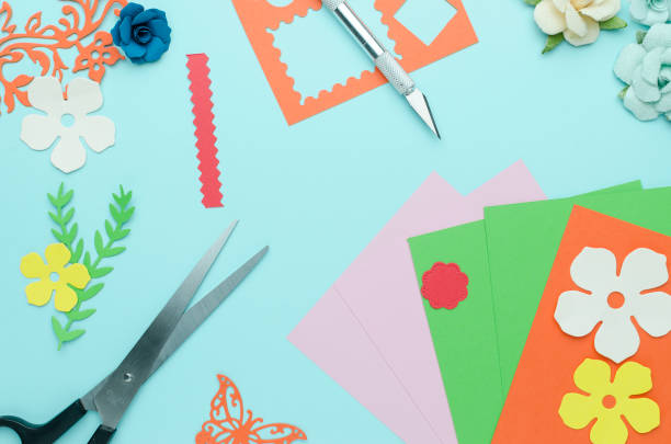 istock scissors, colored paper, cut out shapes and flowers 918041906