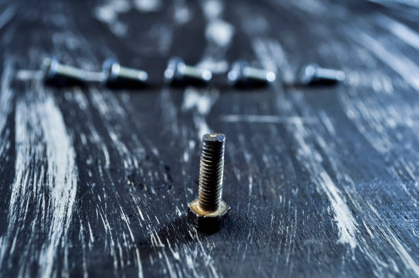 istock Nuts for repairs lying on a wooden table. Iron nuts and screws f 918041942