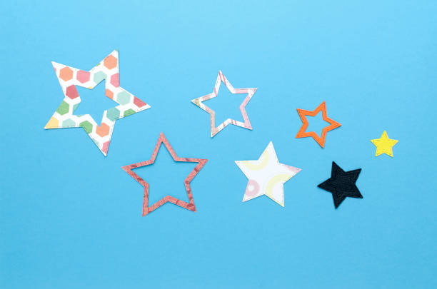 istock colorful flat paper stars on blue background 918041996