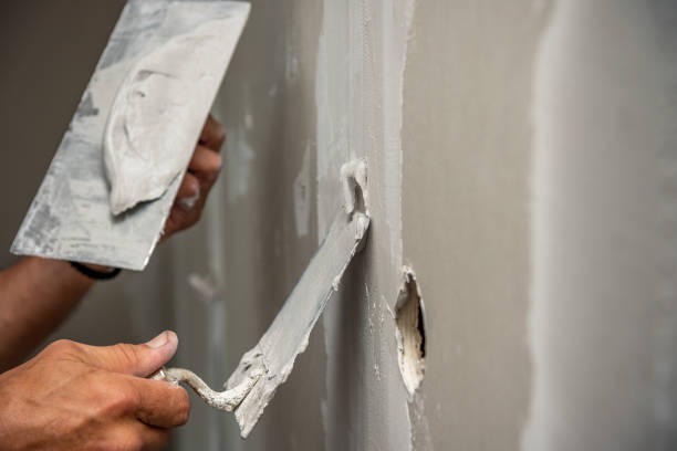 istock old manual worker with wall plastering tools renovating house. 918042342