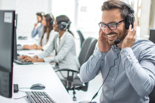 istock Smiling customer service executive with headset working in call center. 918046444