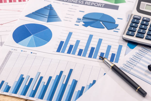 istock Financial development - calculator and pen on chart and graph paper. 918047132