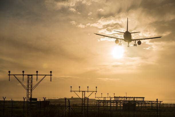 istock Airplane landing at dusk. 918049792