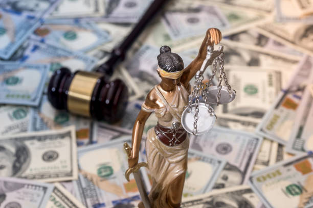 istock Justice Scale and wooden hammer on dollar bills 918050762