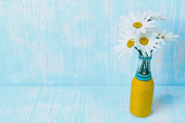 Bouquet of daisies in vase on table