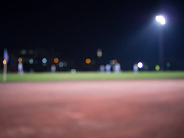 abstract blur background of running track and soccer field, at night. - sports track track and field stadium sport night imagens e fotografias de stock