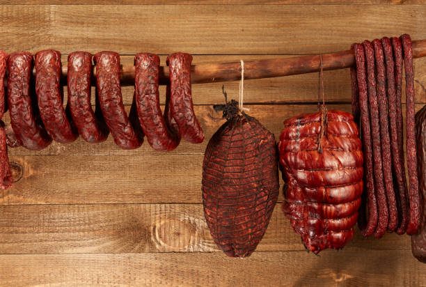 istock Sausage hanged on wooden background 918056810