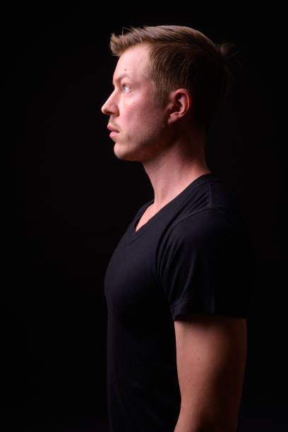 istock Portrait Of Man Against Black Background 918057074