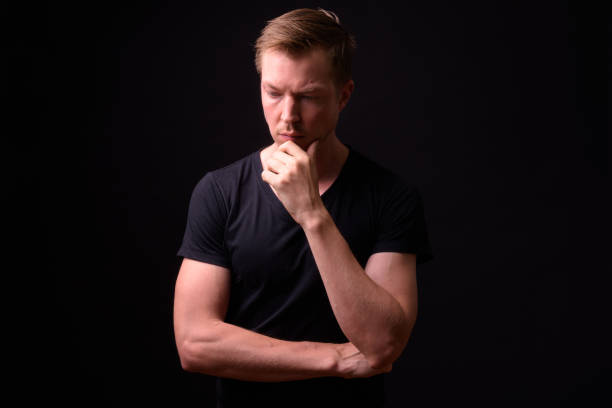 istock Portrait Of Man Against Black Background 918057208