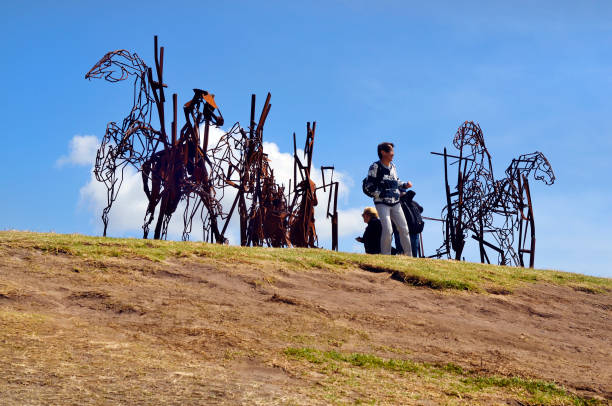 Sydney, NSW, Australia - October 31,2017: Unidentified people by Sculpture by the sea - an outdoor exhibtion along the coast in Bondi, artwork named The Last Charge by Harrie Fasher