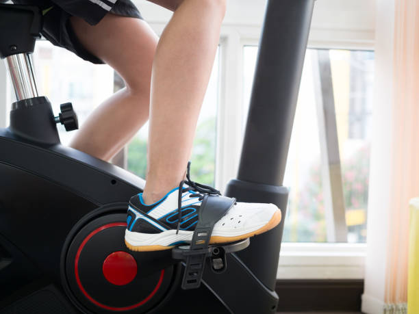 istock A woman is exercising on gym bicycle. 918057740