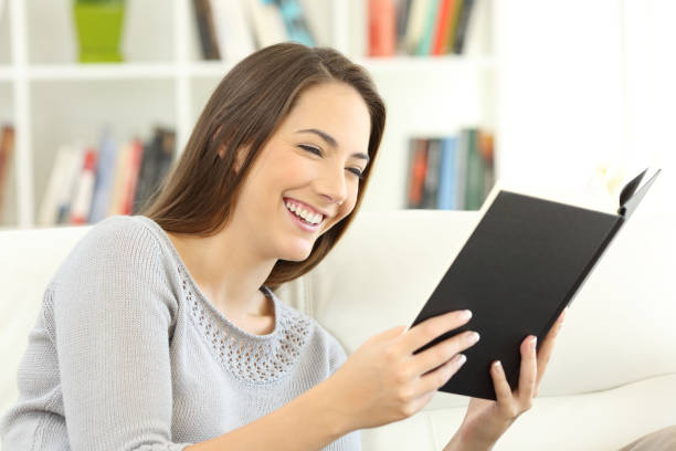 istock Woman enjoying reading a book at home 918060590