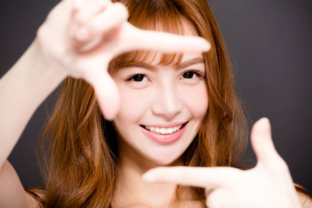 istock young woman making frame with hands and Beautiful eyes concept 918060766