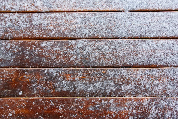 istock snow on brown wooden background 918064848