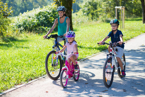 istock Family riding bicycle in park 918065598