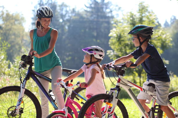 istock Family riding bicycle in park 918065612