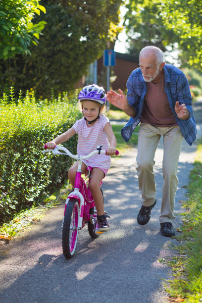 istock Senior man helping granddaughter 918065662