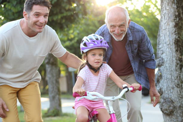 Senior man and father helping girl