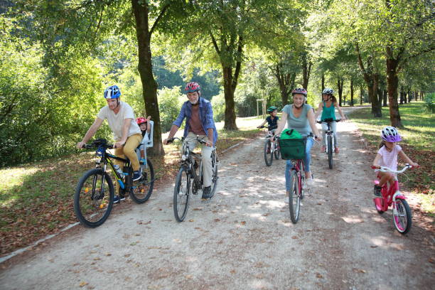 istock Family riding bicycle in park 918065726
