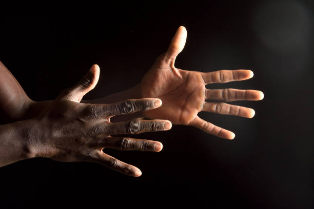istock hand of an african man on black 918072186