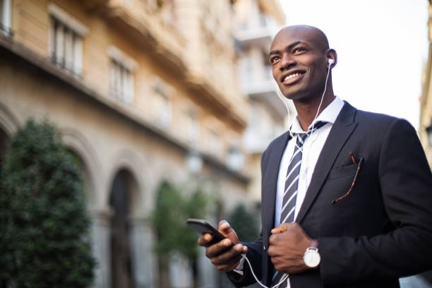 istock Smiling African businissman using mobile phone. 918072680