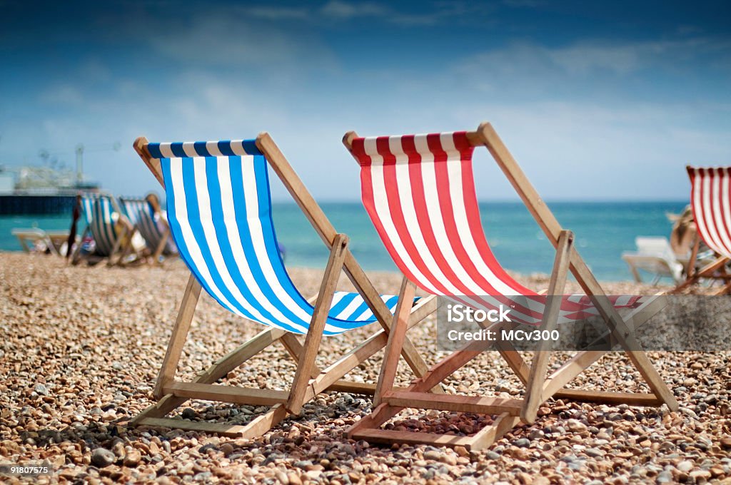 Close up of two deck-chairs on the beach  Adirondack Chair Stock Photo