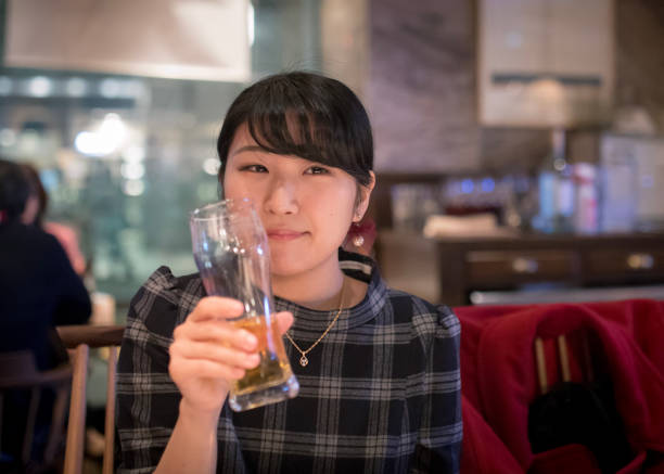 Young woman drinking at night